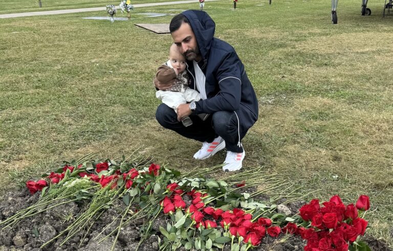 Kash Shaikh and son at Zahed Shaikh's grave.